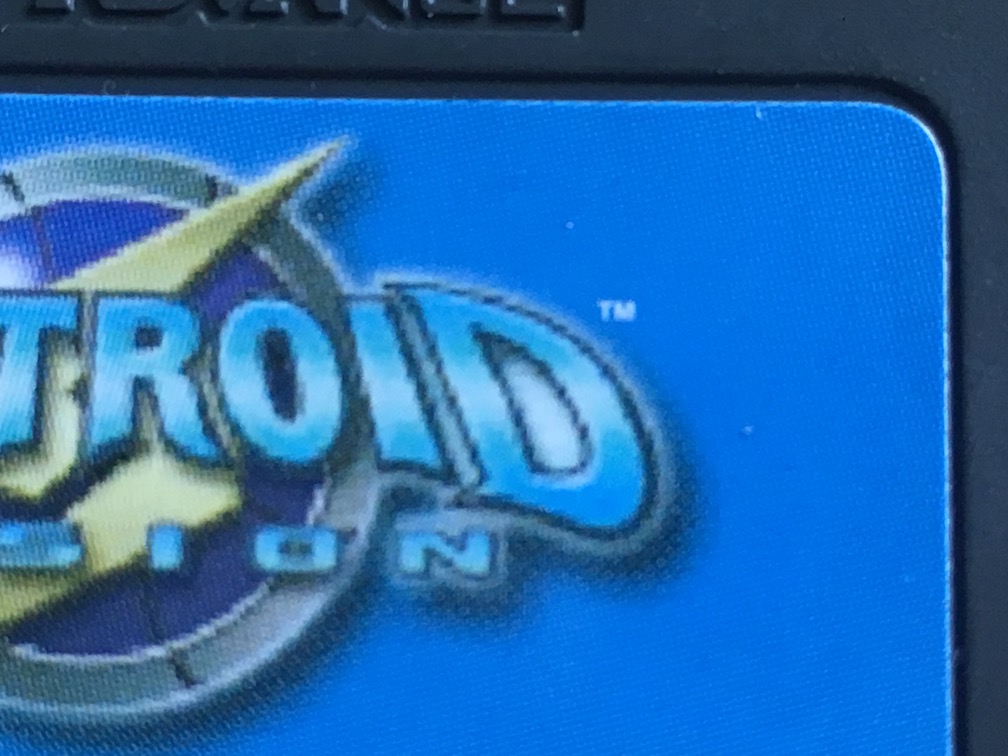 A close-up picture of Metroid Fusion for GBA showing that the logo on the cart is fuzzy