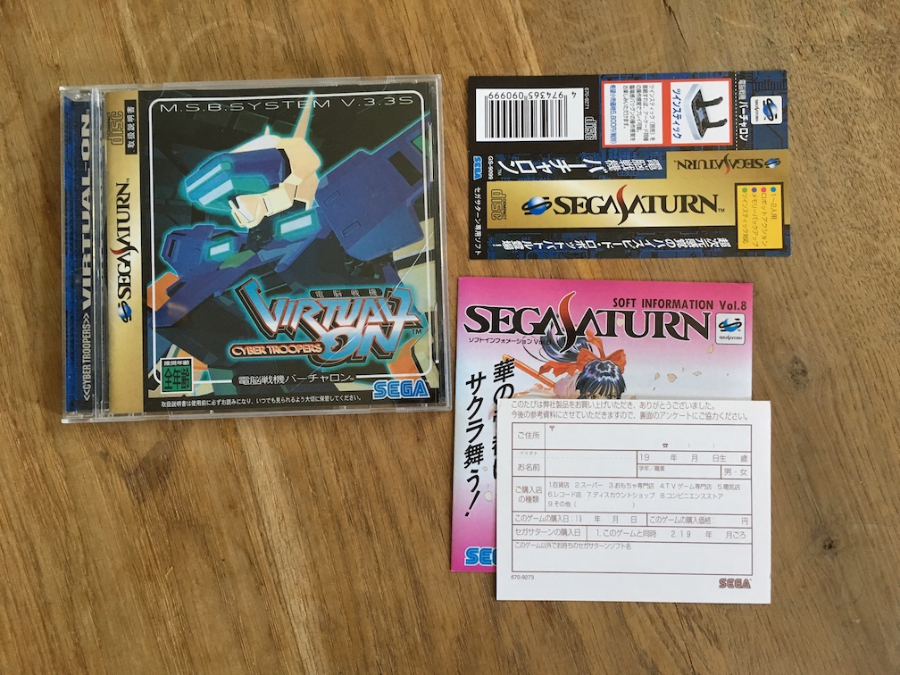 A picture of Virtual On for the SEGA Saturn with the spine and registration card laid out